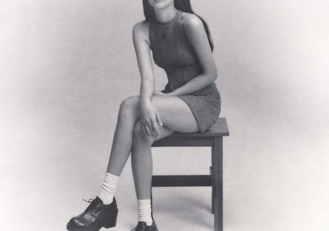 shoe person sitting shorts adult female woman face portrait sneaker