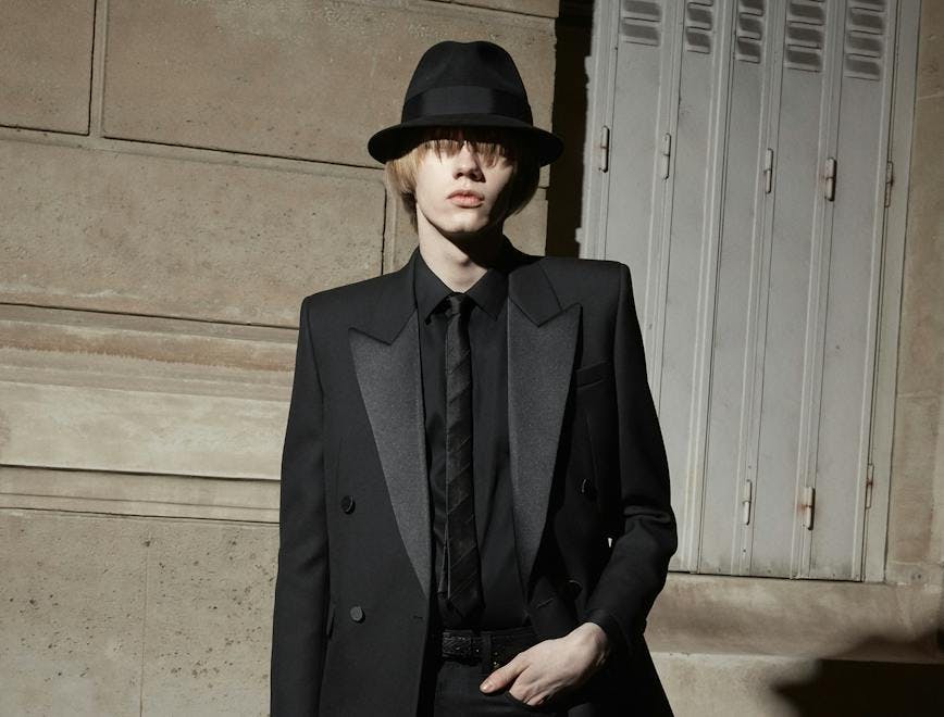 clothing apparel suit overcoat coat tuxedo tie accessories person hat