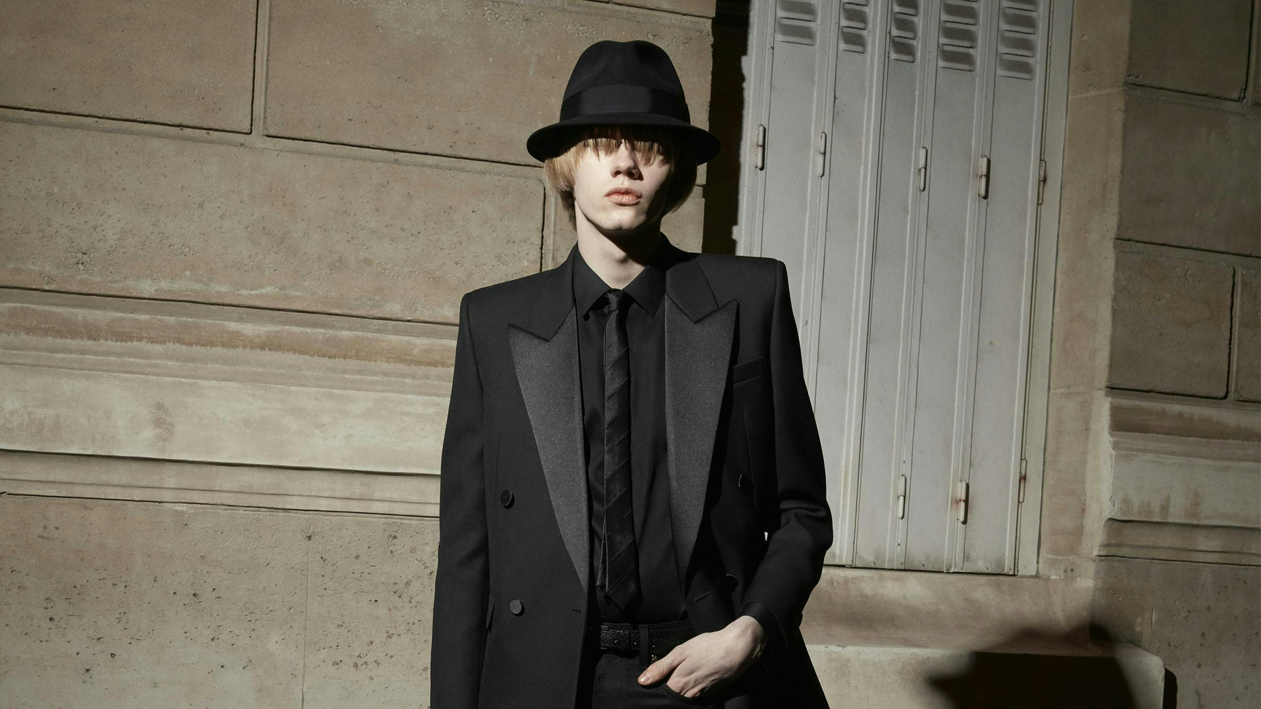 clothing apparel suit overcoat coat tuxedo tie accessories person hat