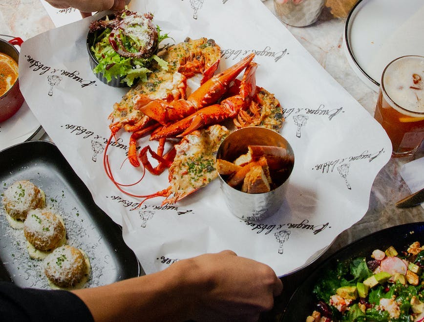 food food presentation cutlery fork meal brunch person lobster seafood knife