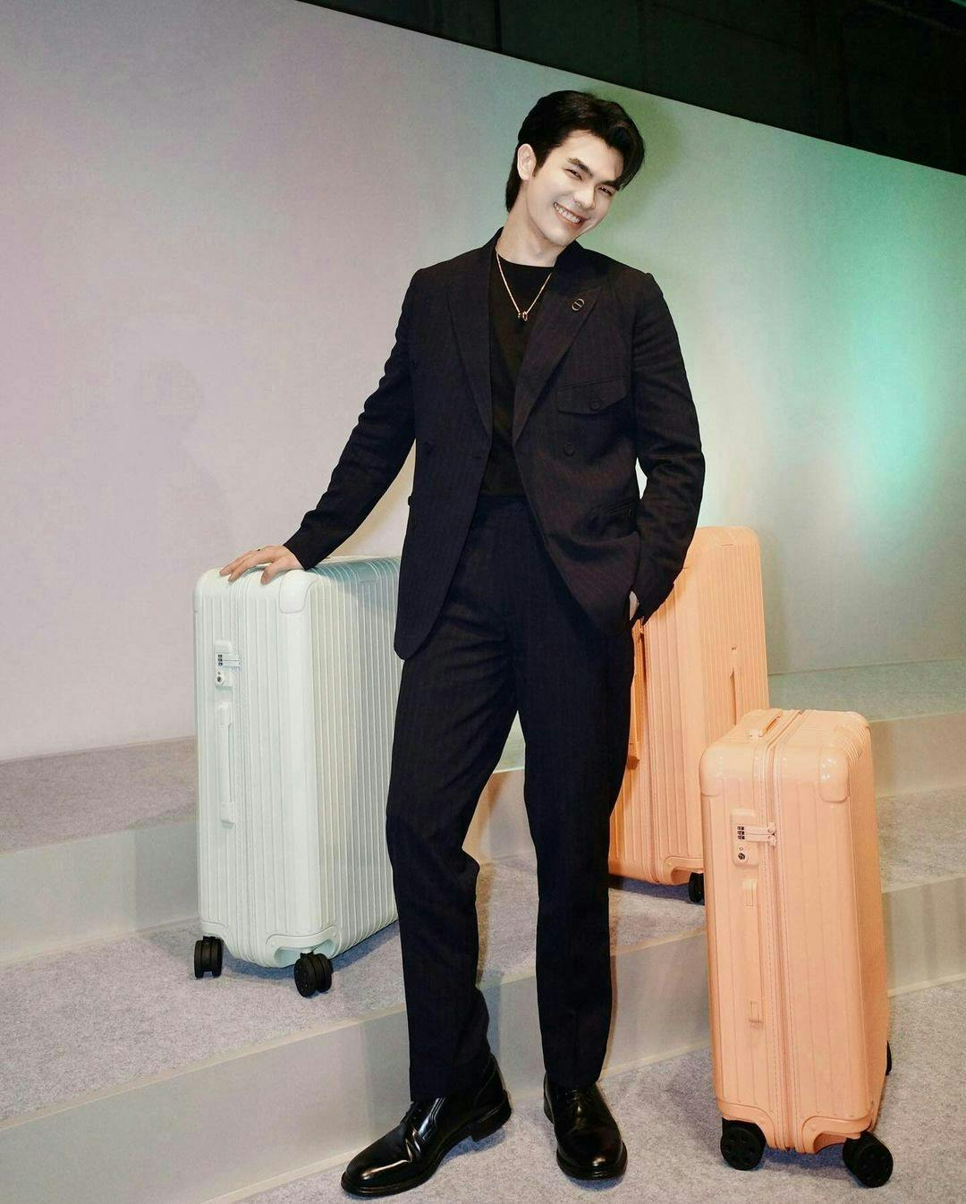 formal wear suit adult male man person baggage standing blazer coat